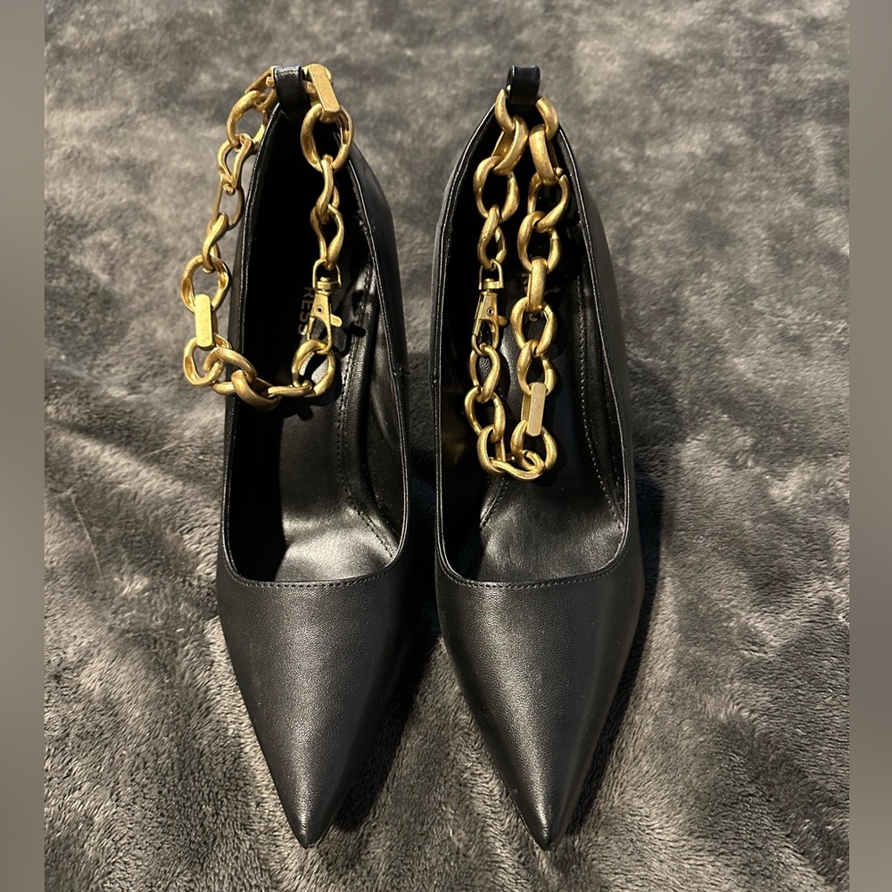 Black stilettos with gold ankle chain
